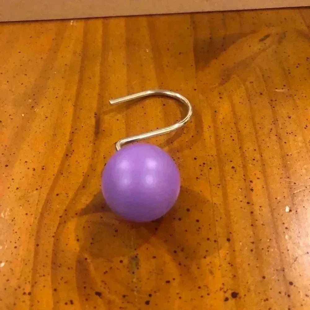Purple wooden shower curtain holders
